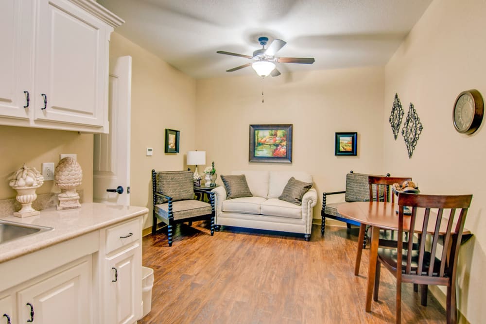An apartment kitchen and living room at Village on the Park Bentonville in Bentonville, Arkansas