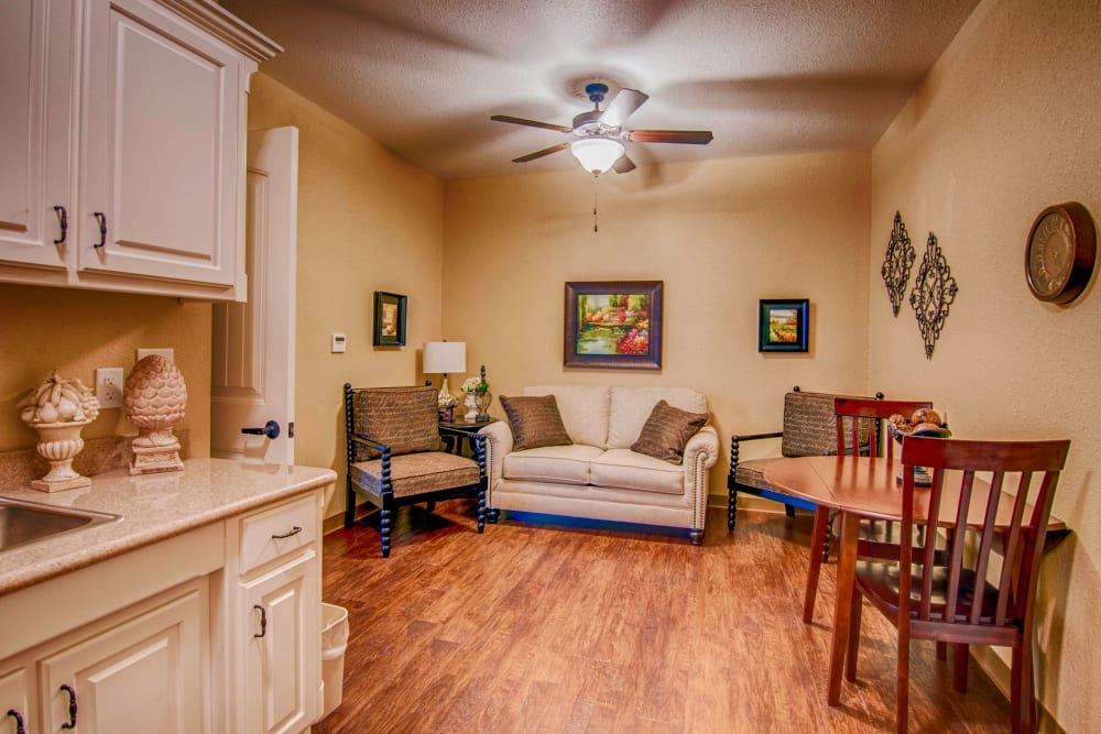 An apartment kitchen and living room at Village on the Park Rogers in Rogers, Arkansas