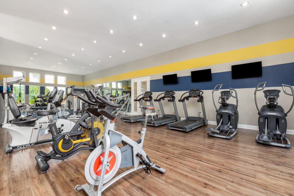 Community exercise room with various exercise equipment at Art Avenue Apartment Homes in Orlando, Florida