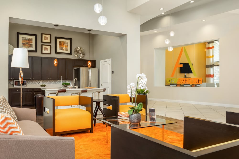Resident common area with trendy lighting and leather seating at Art Avenue Apartment Homes in Orlando, Florida