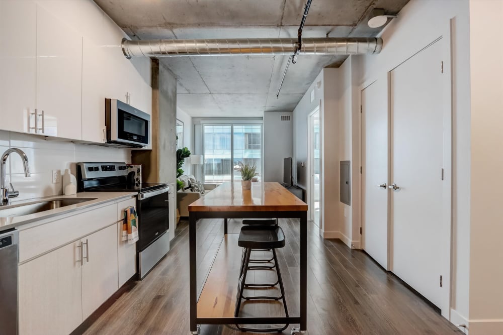 Kitchen with a mobile island in a coliving apartment at Kenect Phoenix in Phoenix, Arizona
