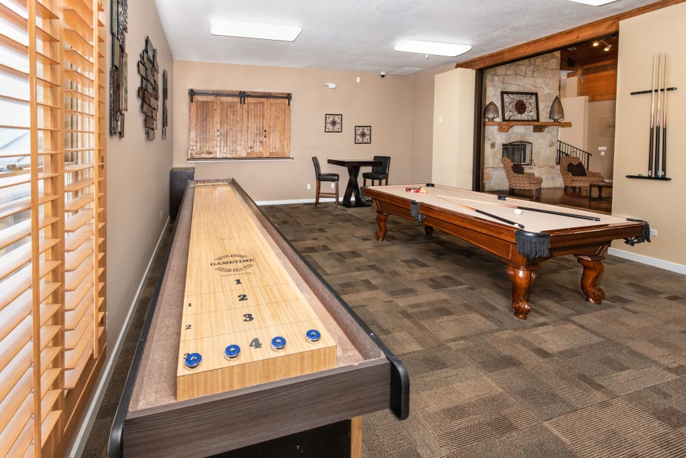 Game room with pool table at El Lago Apartments in McKinney, Texas