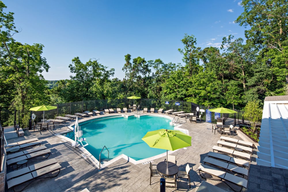 Pool with green umbrellas at Vista at Town Green in Elmsford, New York