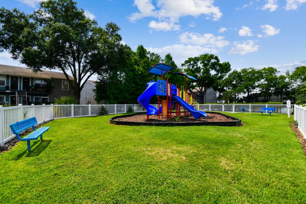Fenced lawn with a children's playground at Coopers Pond in Tampa, Florida