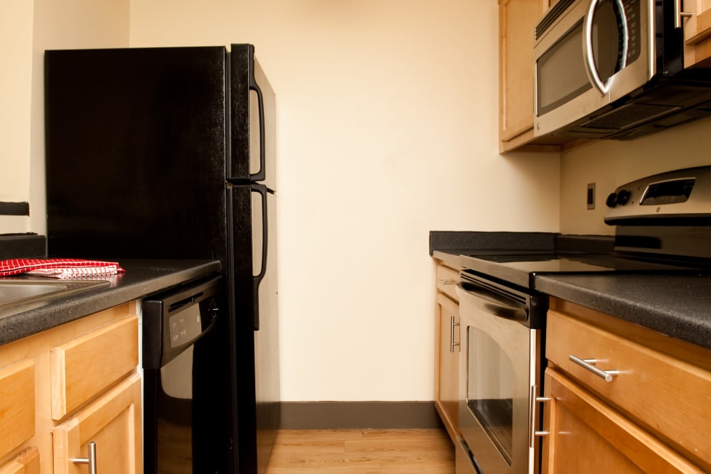 Model kitchen with black refrigerator at Crescent at Shadeland in Lexington, Kentucky