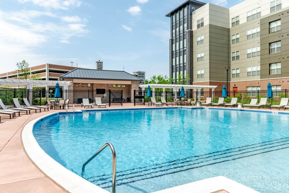Saltwater swimming pool surrounded by lounge chairs at The Residences at Annapolis Junction in Annapolis Junction, Maryland