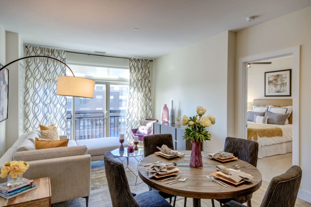 Spacious dining area and living room opening onto a private balcony at The Residences at Annapolis Junction in Annapolis Junction, Maryland