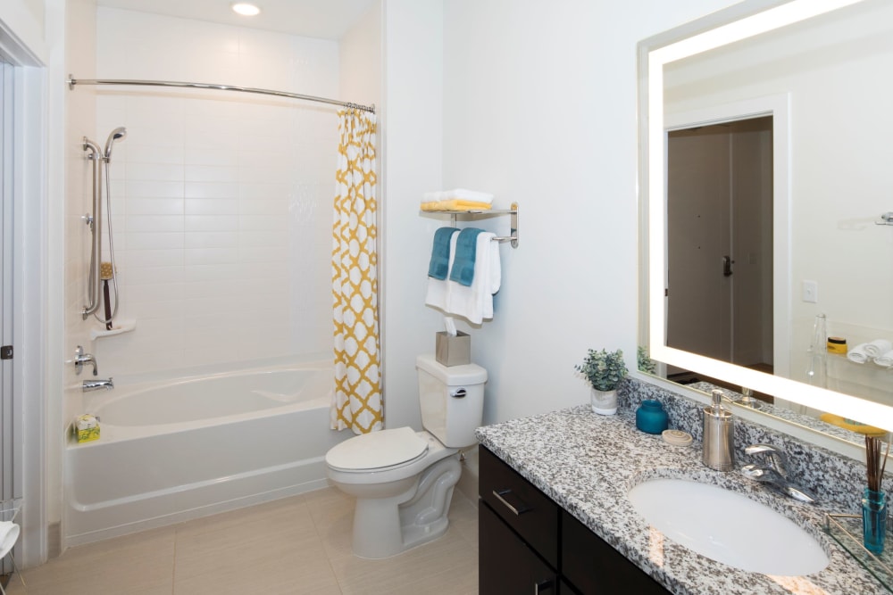 Model bathroom with a tub/shower combination at The Residences at Annapolis Junction in Annapolis Junction, Maryland