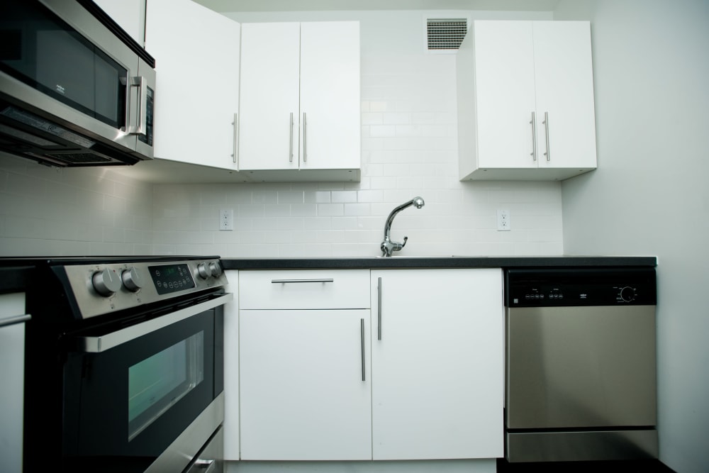 Kitchen with white cabinets and stainless-steel appliances at 3Fifty8 in Lexington, Kentucky