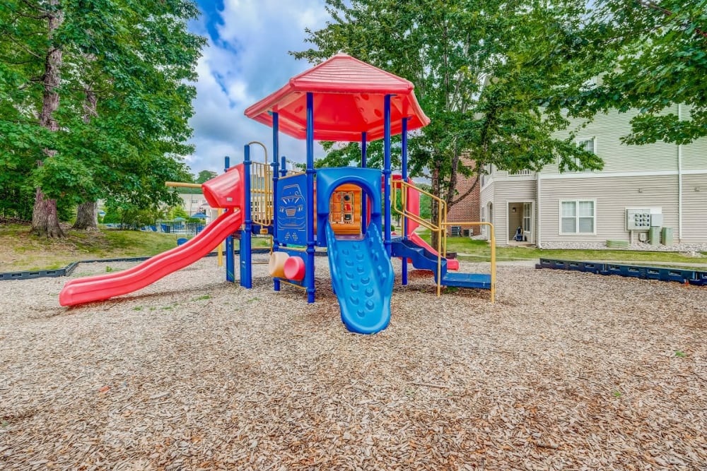 Apartments with a Playground equipped with a slide located at Heather Park Apartment Homes in Garner, North Carolina