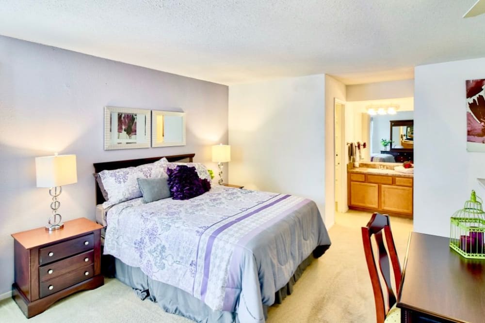 a large bedroom with desk and side tables at Royal Pointe in Virginia Beach, Virginia