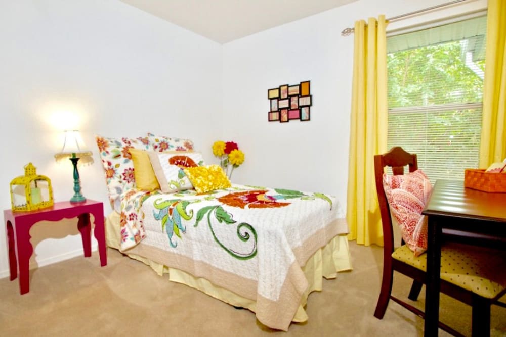 secondary bedroom with embroidered linens at Royal Pointe in Virginia Beach, Virginia