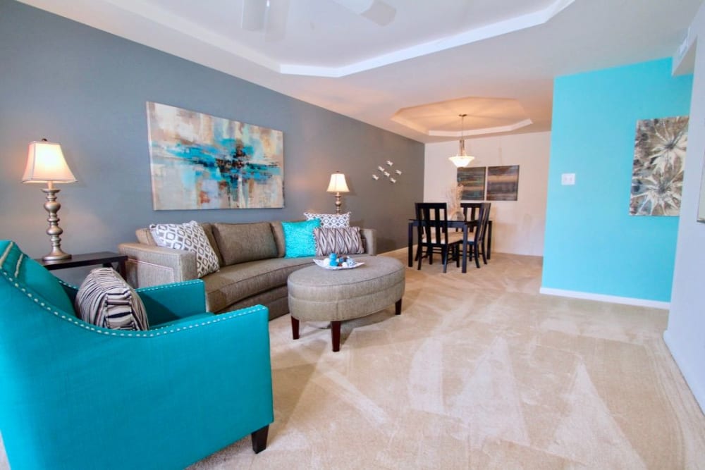 living area with teal furniture at Windsor Lake Apartments in Virginia Beach, Virginia
