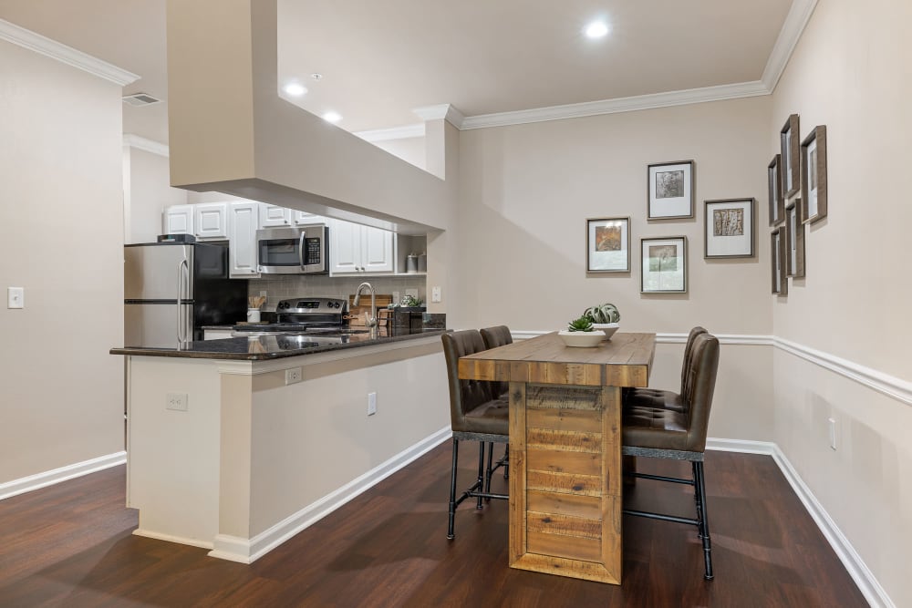 Sleek and modern style living room with private patio at Marquis at Carmel Commons in Charlotte, North Carolina