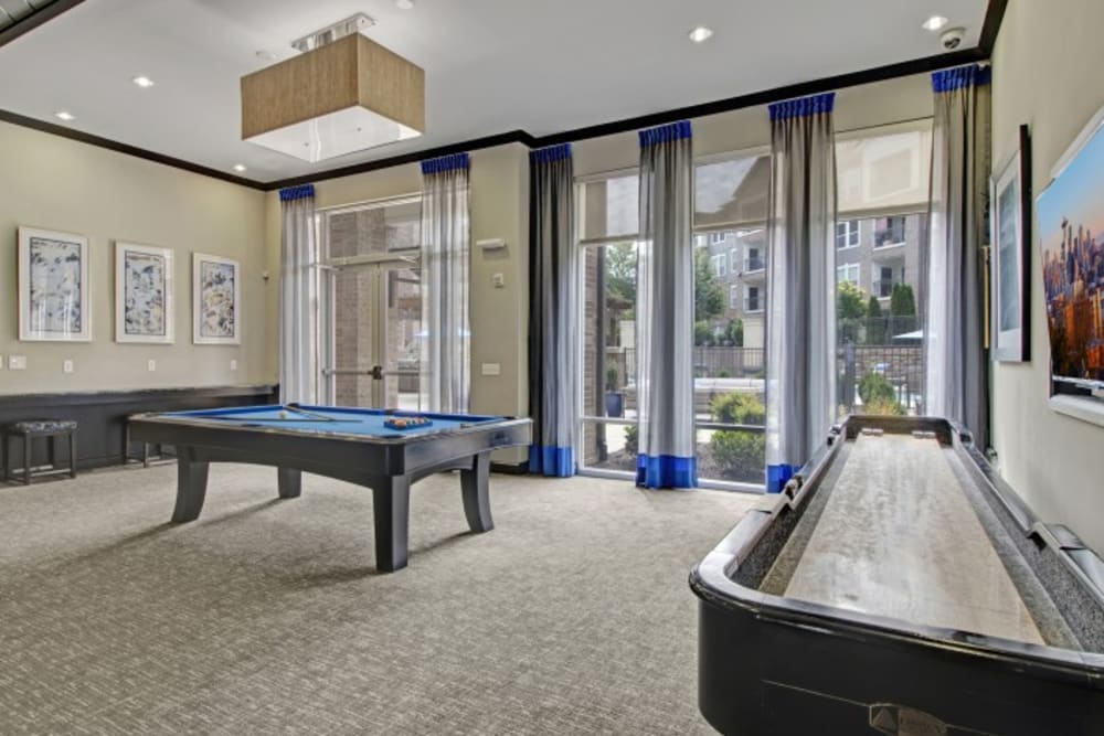 Resident lounge with shuffleboard and a pool table at Artessa in Franklin, Tennessee