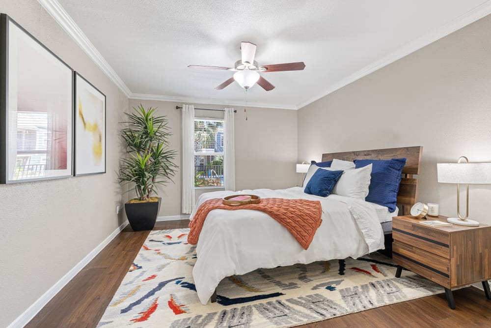 Spacious bedroom with large bed, colorful décor, and ceiling fan at Austin Midtown in Austin, Texas