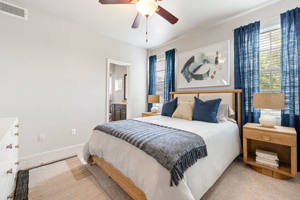 Spacious bedroom with carpet and ceiling fan at Marquis at Stonegate in Fort Worth, Texas