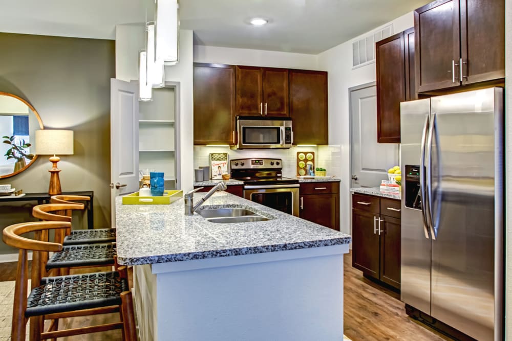 Modern apartment kitchen with an island at The Standard at EastPoint in Baytown, Texas