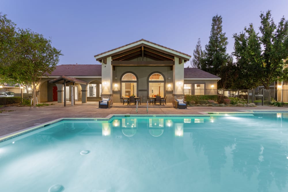 Outdoor community pool in the evening at Sierra Oaks Apartments in Turlock, California