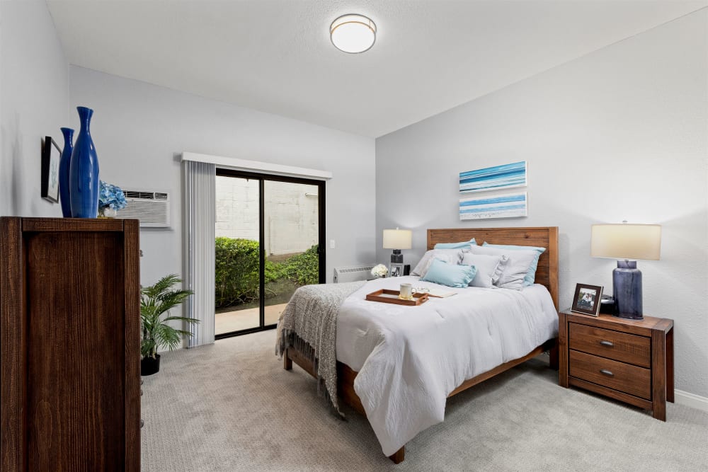 Bedroom with a glass door at Pacifica Senior Living Vista in Vista, California