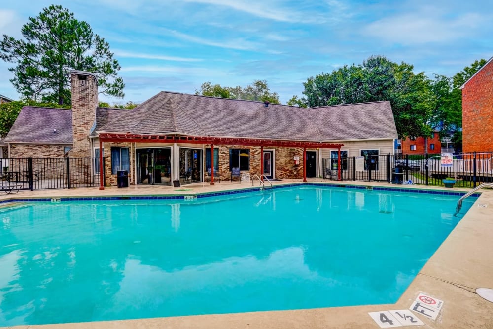 Swimming pool with clubhouse in background at Gable Hill Apartment Homes in Columbia, South Carolina
