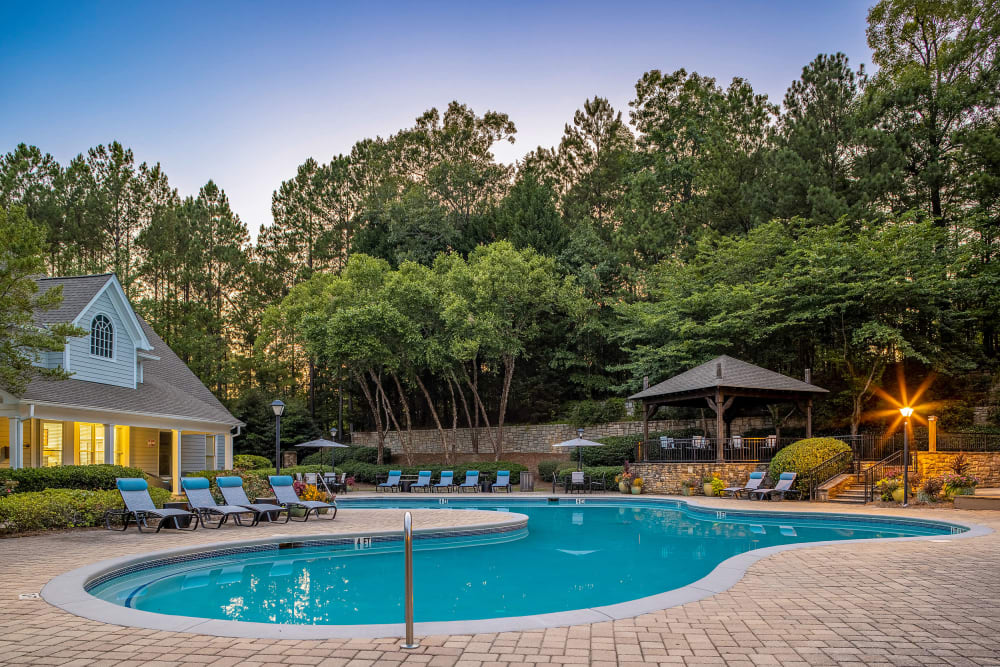 Sparkling pool with lounge chairs overlooking clubhouse at Marquis at Sugarloaf in Duluth, Georgia
