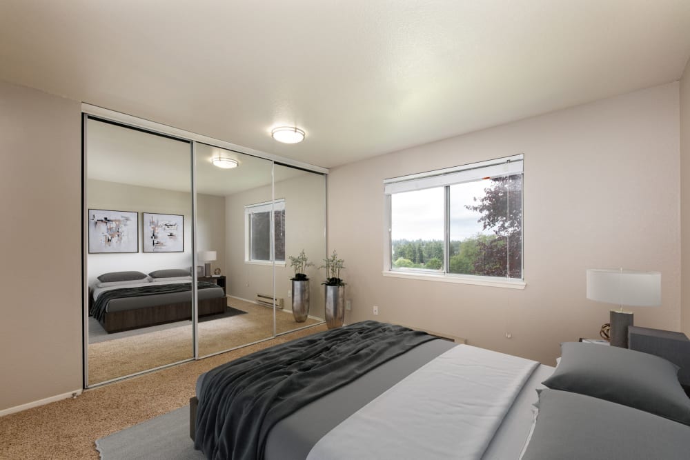 Master bedroom with a large closet at Latitude Apartments in Everett, Washington