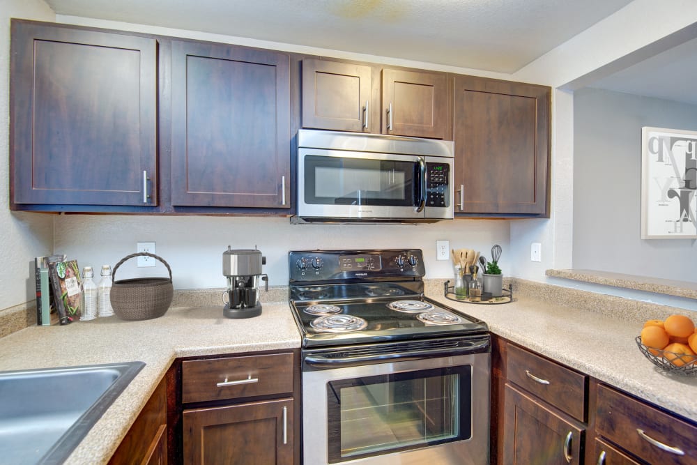 Kitchen with wood-style flooring at Latitude Apartments in Everett, Washington