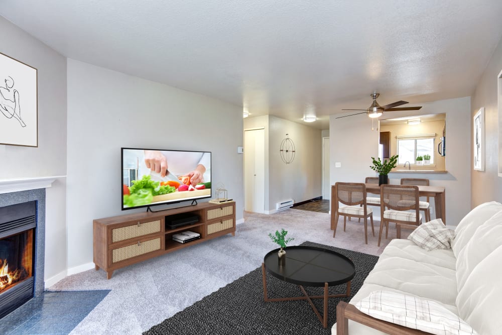 A living room complete with a private patio and fireplace at Latitude Apartments in Everett, Washington