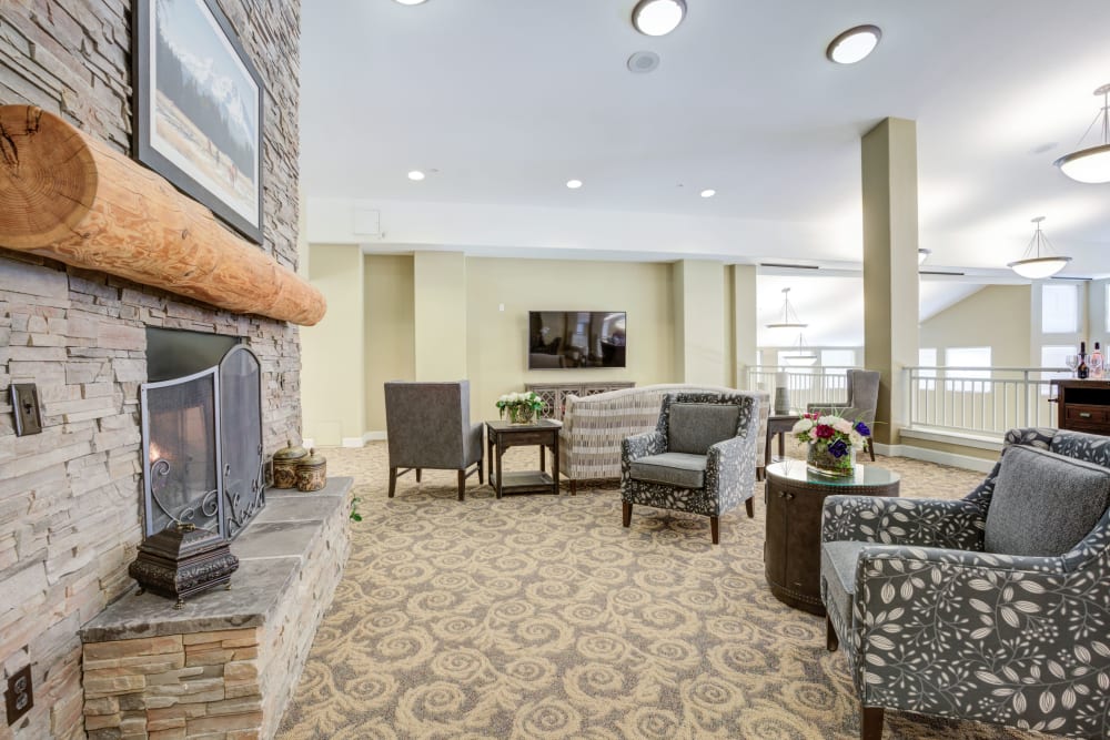 Lounge area with fireplace at Timber Pointe Senior Living in Springfield, Oregon. 