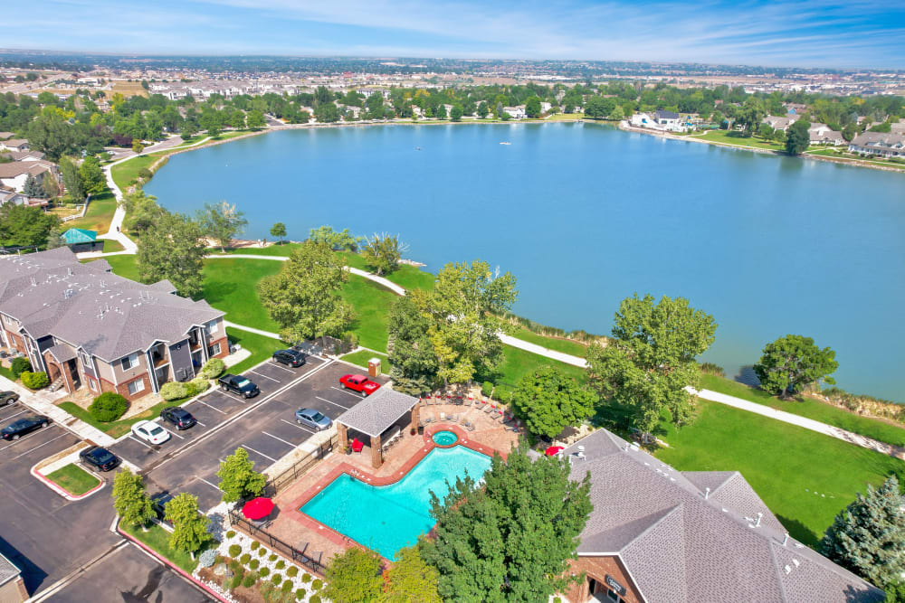 Swimming pool with a sundeck and lounge chairs Aerial at Promenade at Hunter's Glen Apartments in Thornton, Colorado