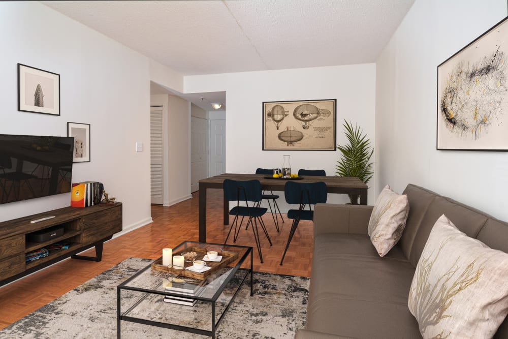 Living room and dining area of a model home with hardwood floors at The Brunswick in New Brunswick, New Jersey