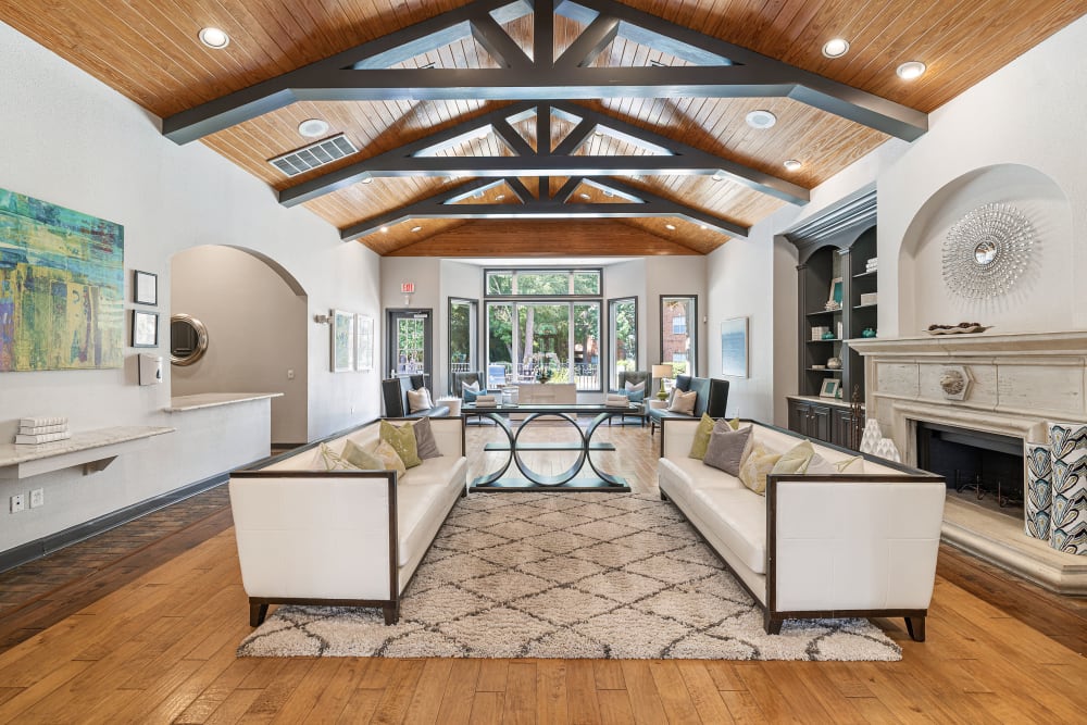 Modern and bright community clubhouse sitting area with wood flooring at Marquis at Kingwood in Kingwood, Texas