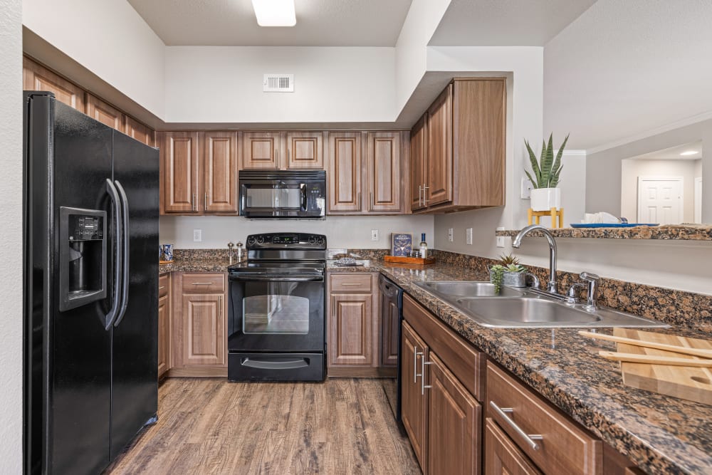 Kitchen with black appliances at Marquis at Westchase in Houston, Texas