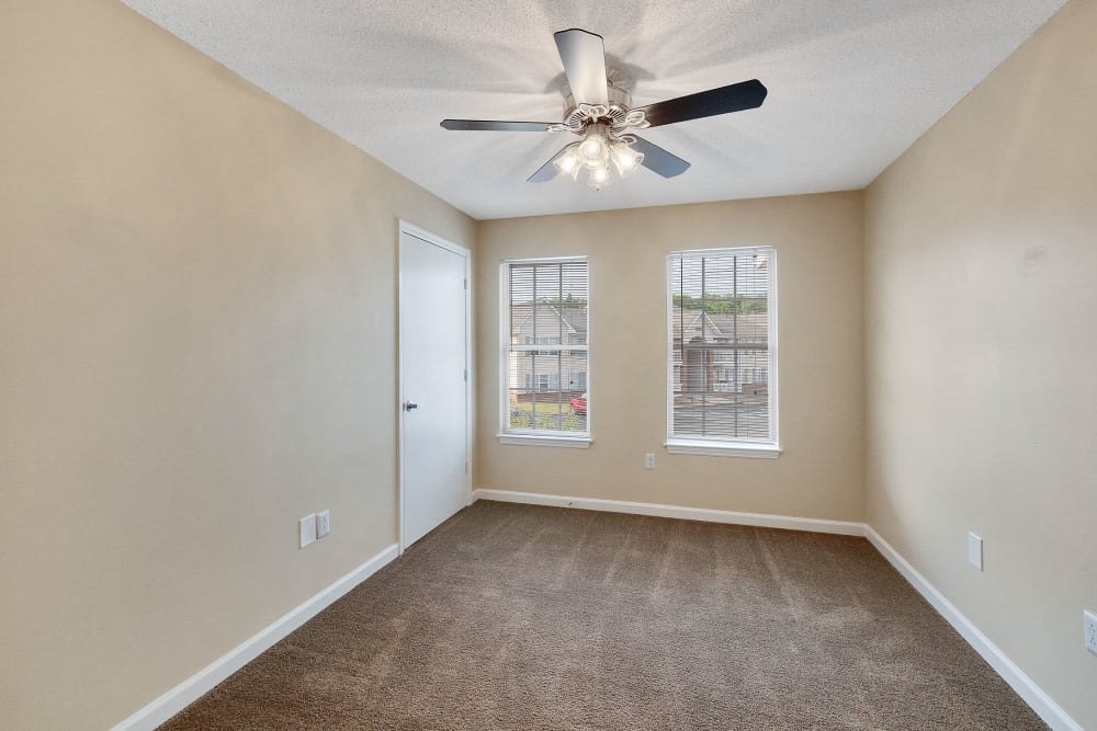 Bedroom with ceiling fan at The Cove at Cloud Springs Apartment Homes in Fort Oglethorpe, Georgia