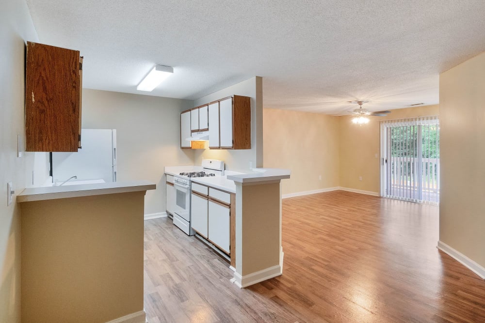 Kitchen with wood cabinets at The Cove at Cloud Springs Apartment Homes in Fort Oglethorpe, Georgia