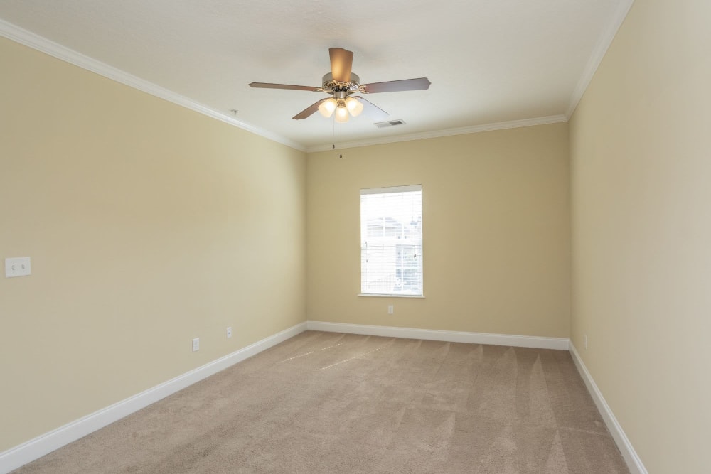 Bedroom with window and ceiling fan at Sage Creek Apartments in Augusta, Georgia