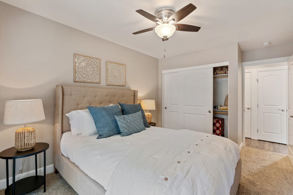 Model bedroom with ceiling fan at Pinebrook Apartment Homes in Fremont, California