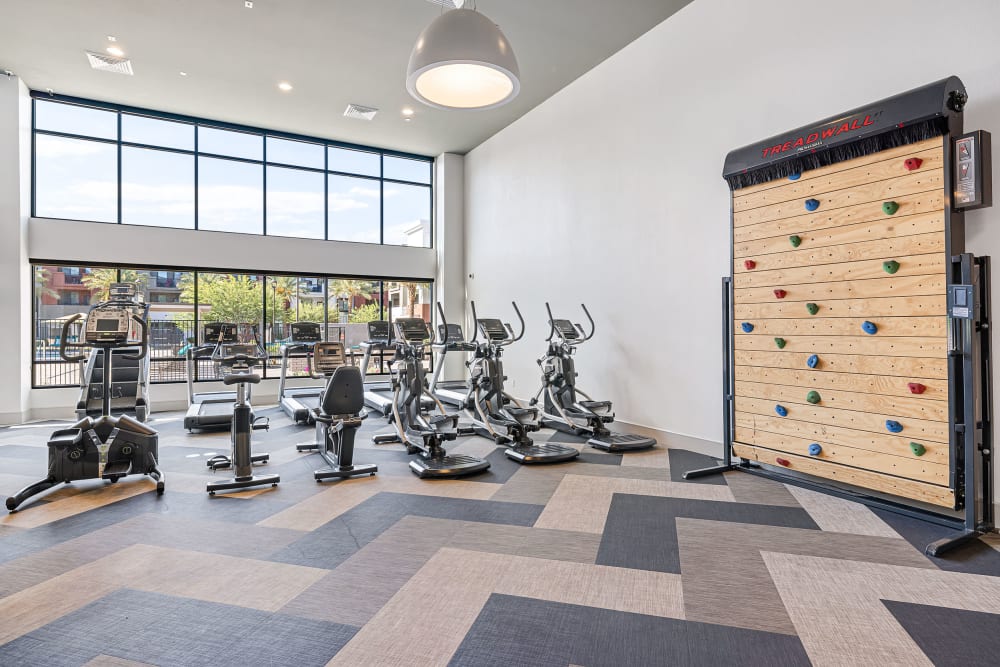 Exercise machines and rock climbing wall at Marquis at Chandler in Chandler, Arizona