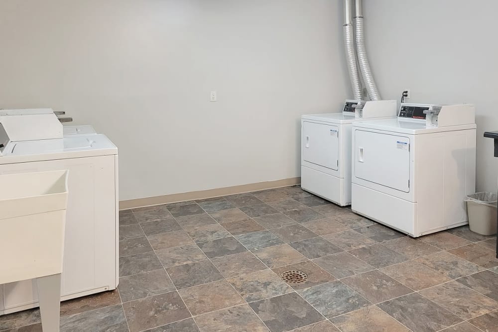 Laundry room with washers, dryers and a sink