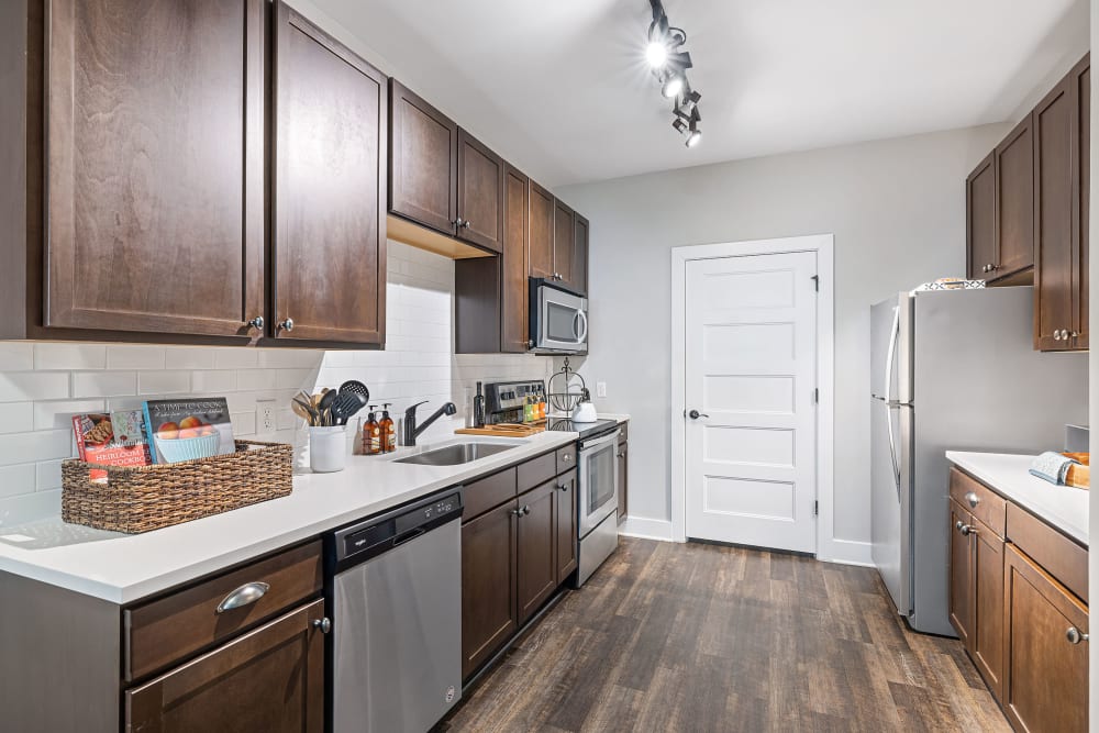 Modern style kitchen with espresso cabinets and stainless steel appliances at Marquis at Buckhead in Atlanta, Georgia