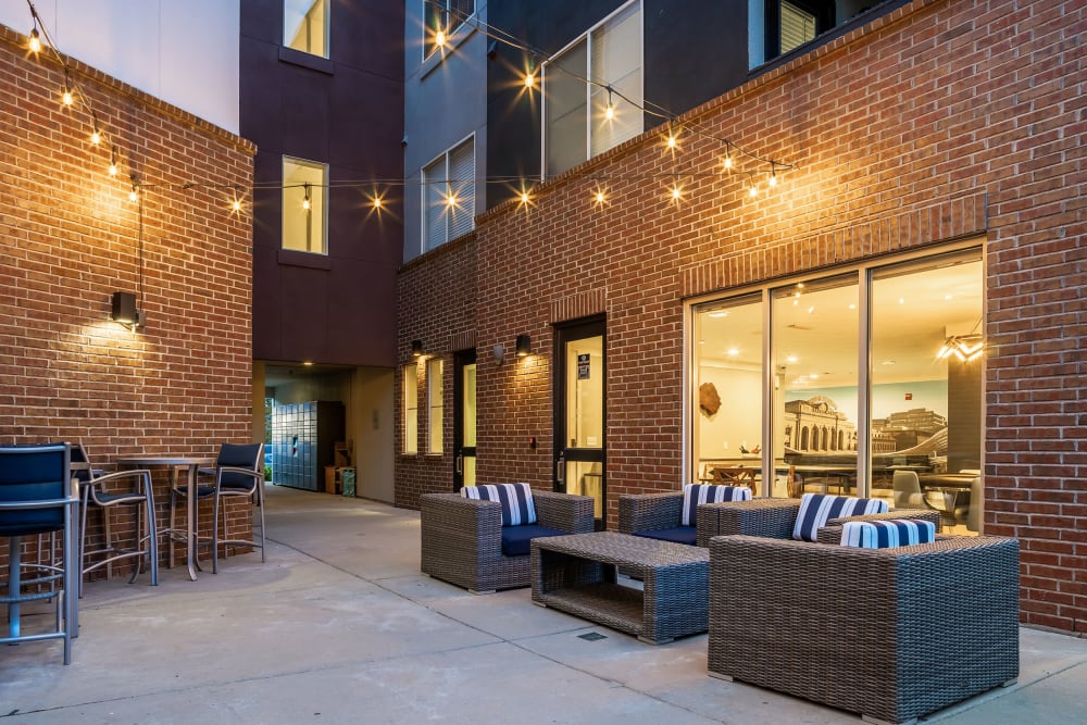 Ground floor patio seating with lights at Marq Inverness in Englewood, Colorado