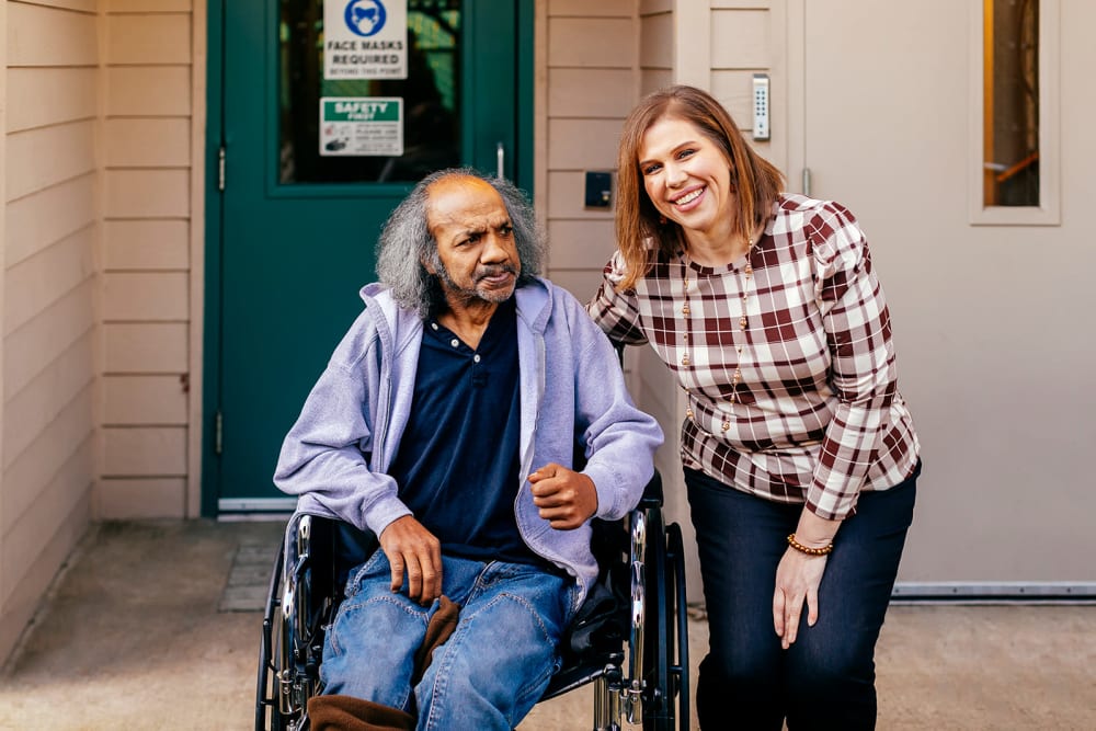 Director and a resident in a wheelchair at Cascade Park Gardens Memory Care in Tacoma, Washington