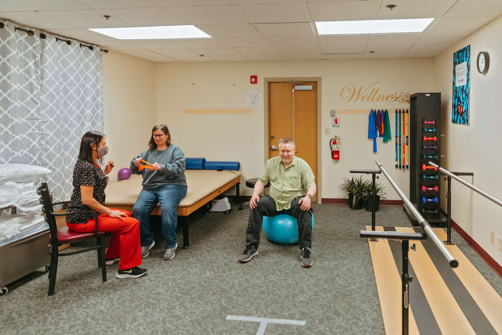 Residents and caregiver doing sitting excercises at Cascade Park Adult Day Health in Tacoma, Washington