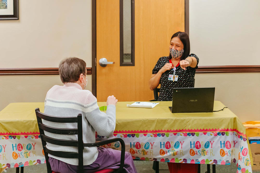 Happy resident and caregiver at Cascade Park Adult Day Health in Tacoma, Washington