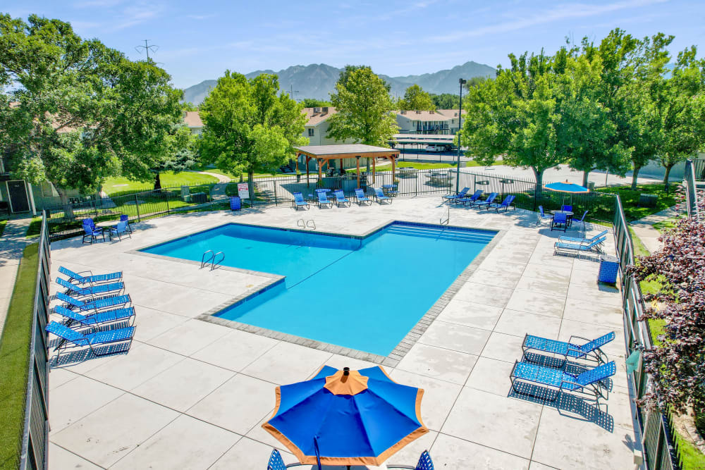 Beautiful resort-style swimming pool with a lush backdrop at Callaway Apartments in Taylorsville, Utah