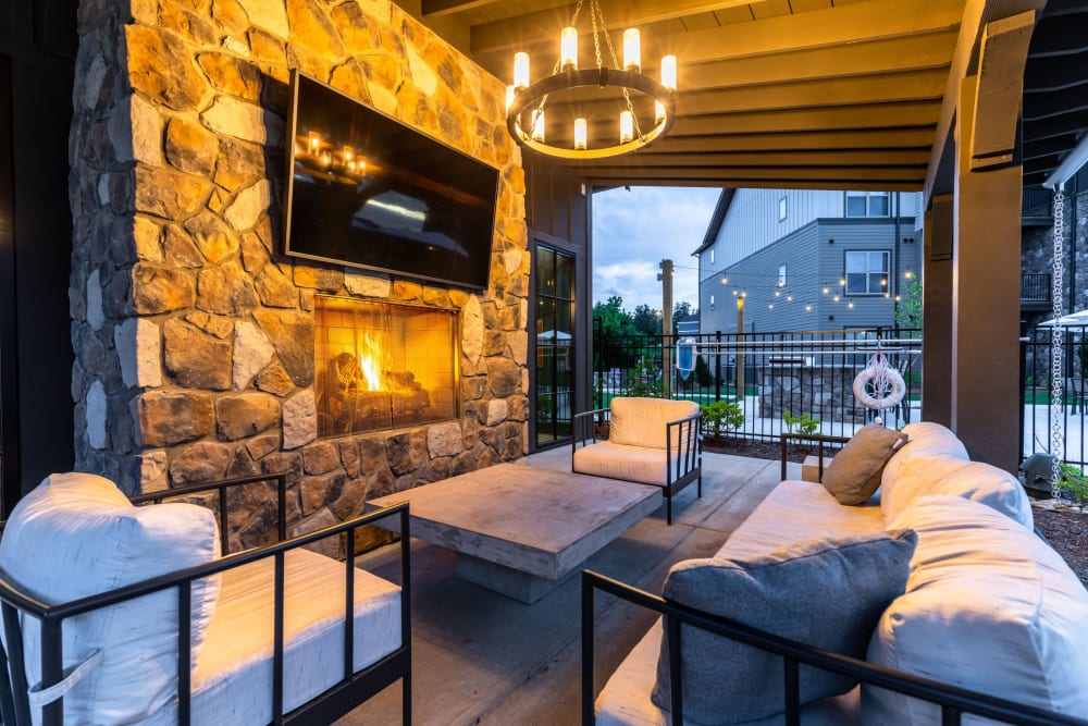 Outdoor lounge with a TV at The Holston | Apartments in Weaverville, North Carolina
