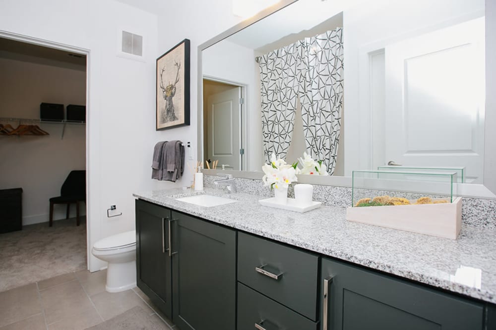 Model bathroom with granite countertops at Marq Music Row in Nashville, Tennessee
