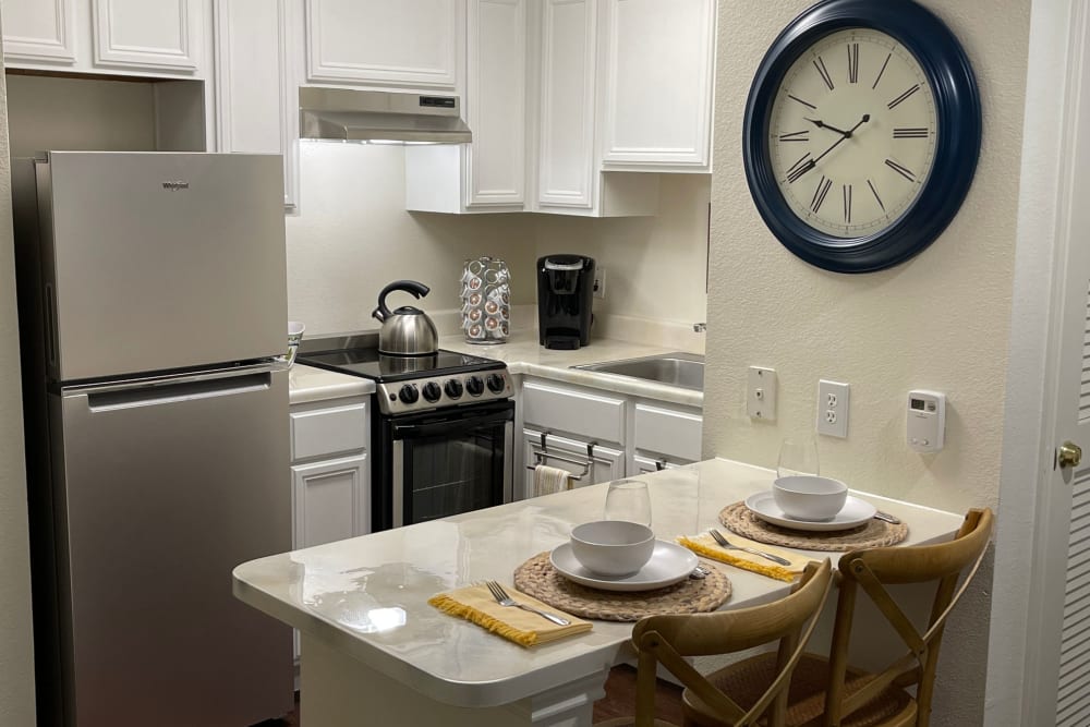 One bedroom unit kitchen area at Carriage Inn Conroe in Conroe, Texas