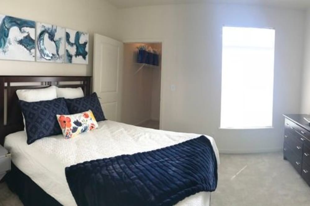 Resident bedroom with walk-in closet at Lakeshore Apartment Homes in Evansville, Indiana